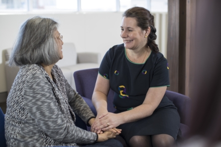 Icon treatment nurse offering support to cancer patient.