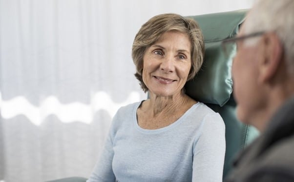 Cancer consultant reassuring patient.